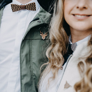 Woman and man with bow ties and brooches